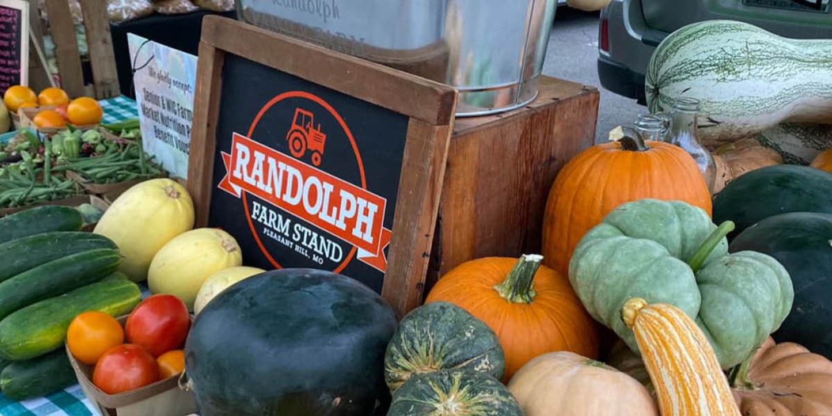 farmers market stand with fall vegetables